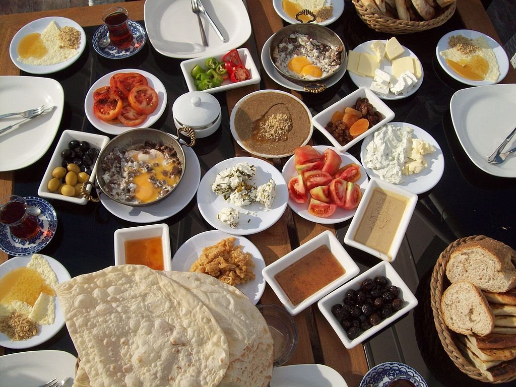 TURKEY: A traditional breakfast consists of bread, cheese, butter, olives, eggs, tomatoes, cucumbers, jam, honey, and kaymak. It can also include sucuk, a spicy Turkish sausage, and Turkish tea.